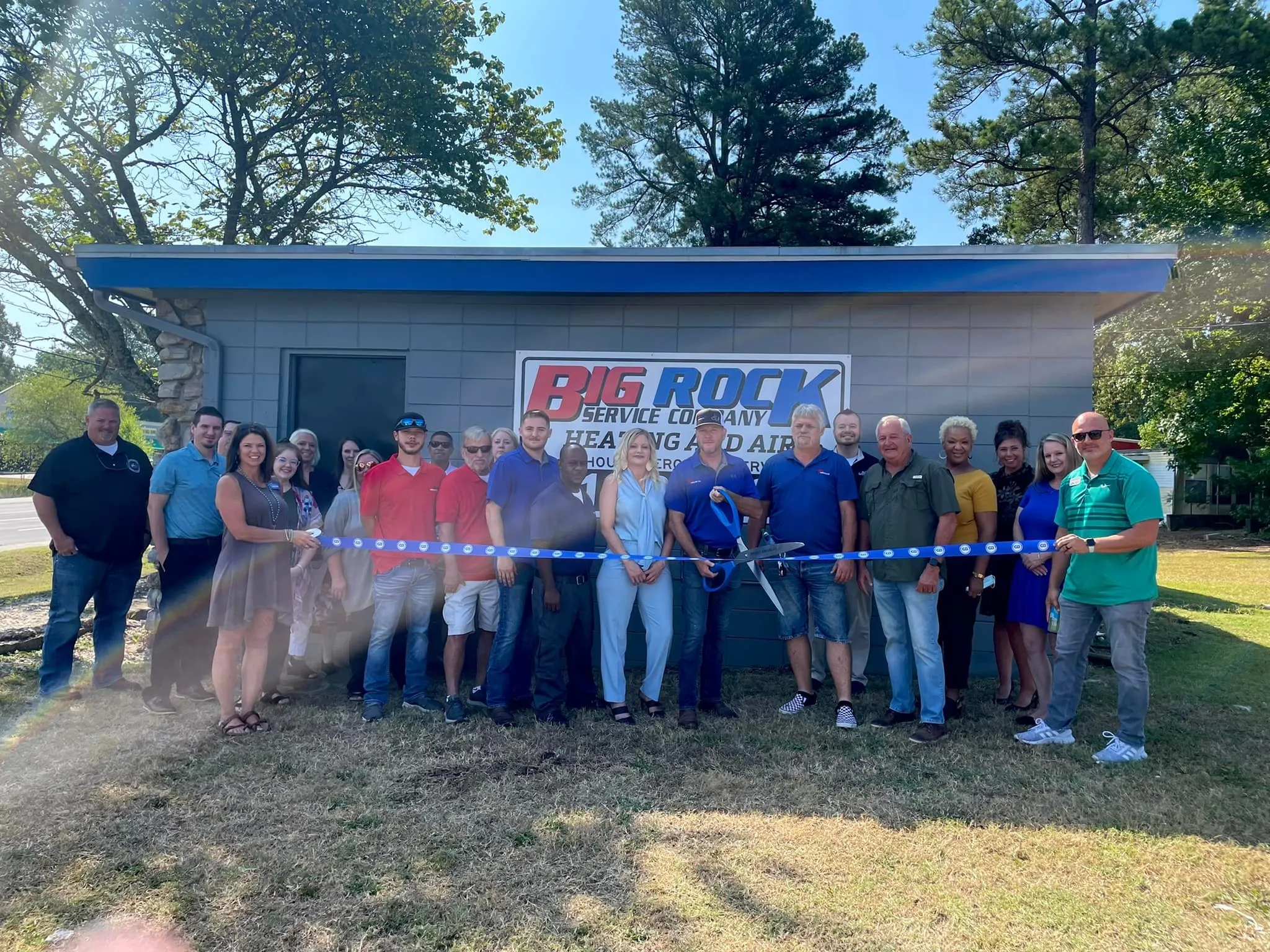 Community members celebrating a ribbon-cutting for Big Rock Service Company